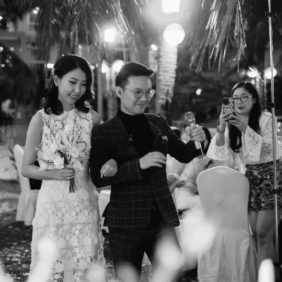Emotional black-and-white moment of Kenz Tran walking with his bride, symbolizing the humanity behind the founder of MOCHIMIN and Lazy Prompter.